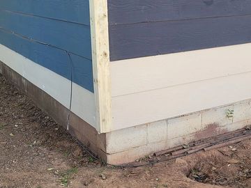 New white siding added to blue home