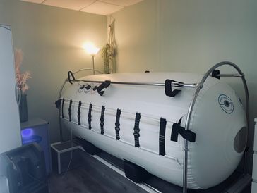 Hyperbaric oxygen therapy chamber in a room.