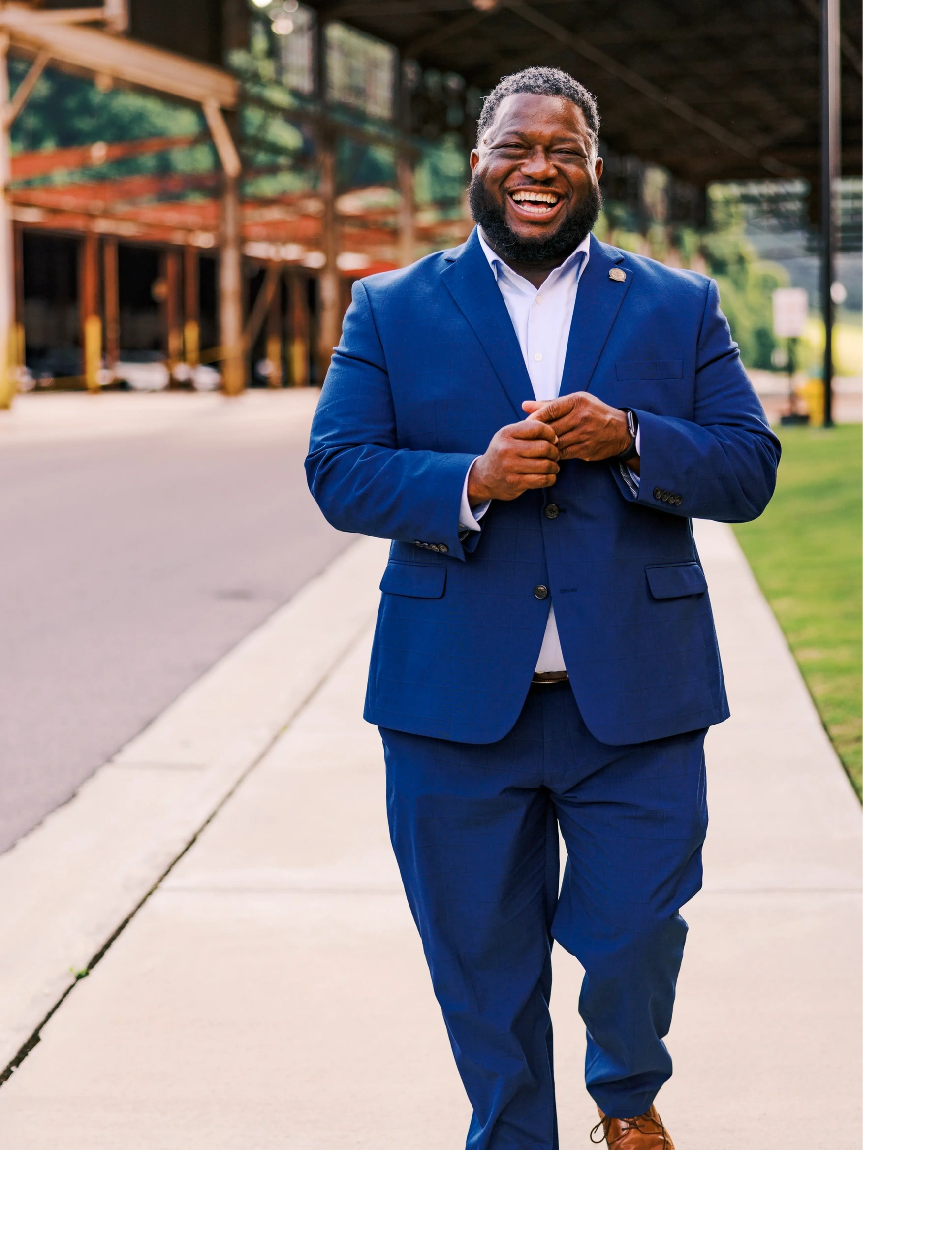 Councilman Jackson smiling and walking down the sidewalk