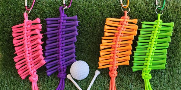 Golf tee holders in pink, purple, or green.  Holds 18 Golf tees. Just clip to your golf caddy bag.