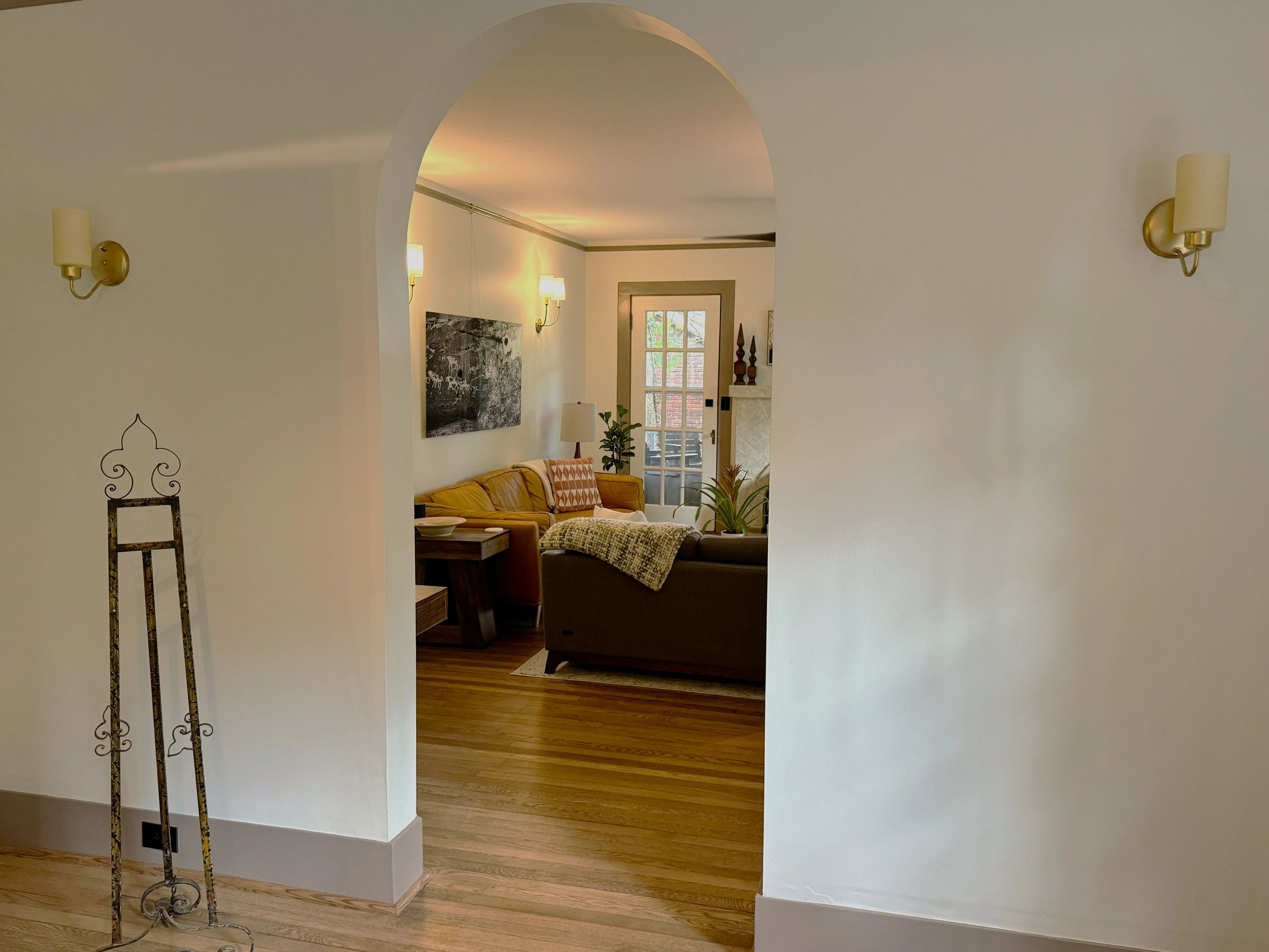 Cozy living room viewed through an arched doorway.