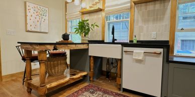 Cozy kitchen corner with wooden island and farmhouse sink.