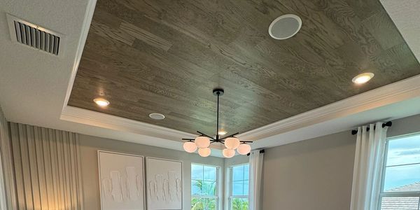 Modern bedroom with wood-paneled ceiling and cozy bed.
