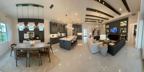 Modern open-concept living area with kitchen, dining, and lounge spaces.