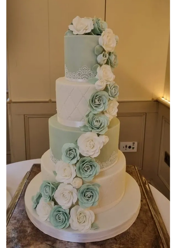 Sage green 4 tier Wedding cake with handmade roses sash