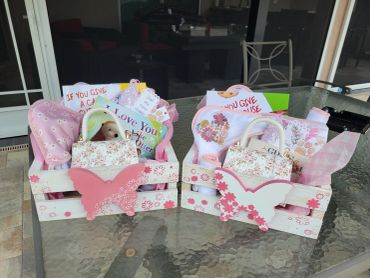 Two decorative gift baskets with butterfly accents and greeting cards.