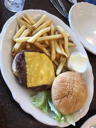A Hamburger With Fries On The Side