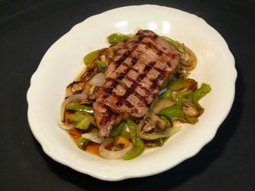 A Grilled Meat Piece With Vegetables