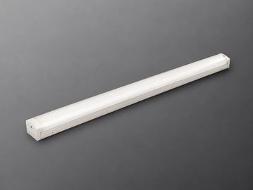 A white LED tube light on a gray surface.