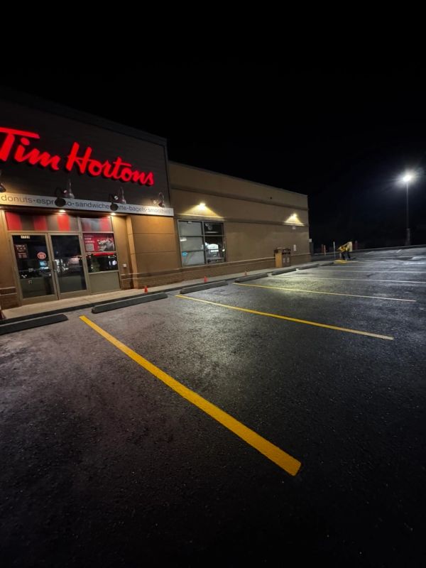 Empty Tim Hortons parking lot at night.