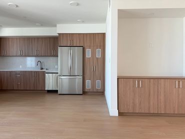 Modern kitchen with wooden cabinets and stainless steel appliances.