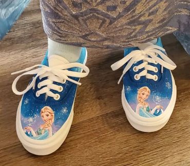 Blue sneakers featuring Elsa from Frozen with snowflake designs.