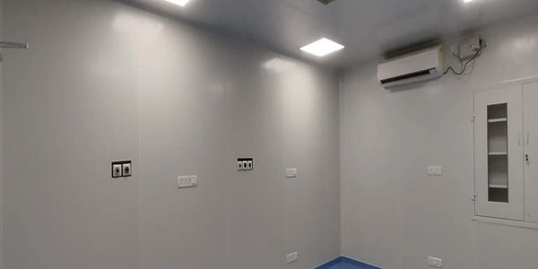 Empty room with electrical outlets and air conditioning unit.