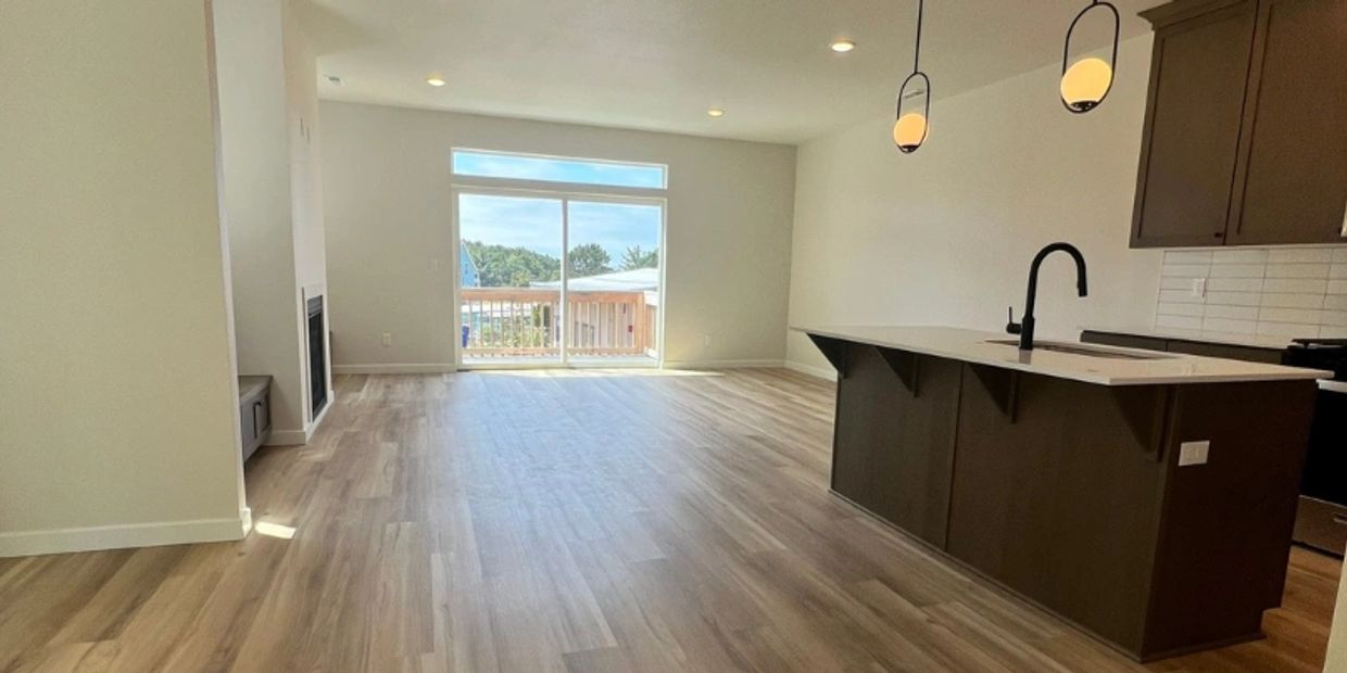 Bright open living space with modern kitchen island and large sliding doors.
