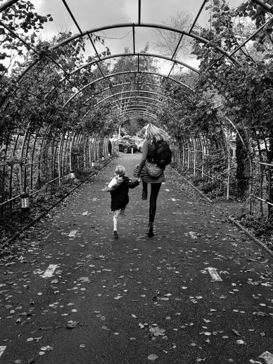 Young mother and her little daughter at beautiful autumn park.