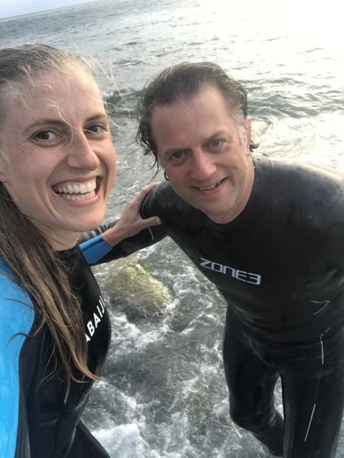 Pretty young loving couple taking selfie together on smartphone on the beach.