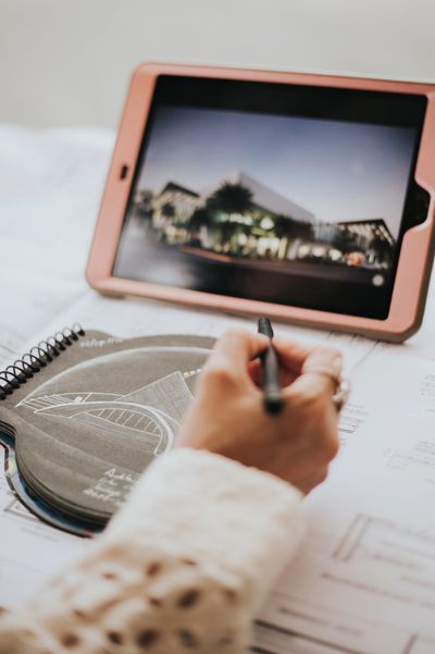 Female architect working with stylus on electronic tablet
