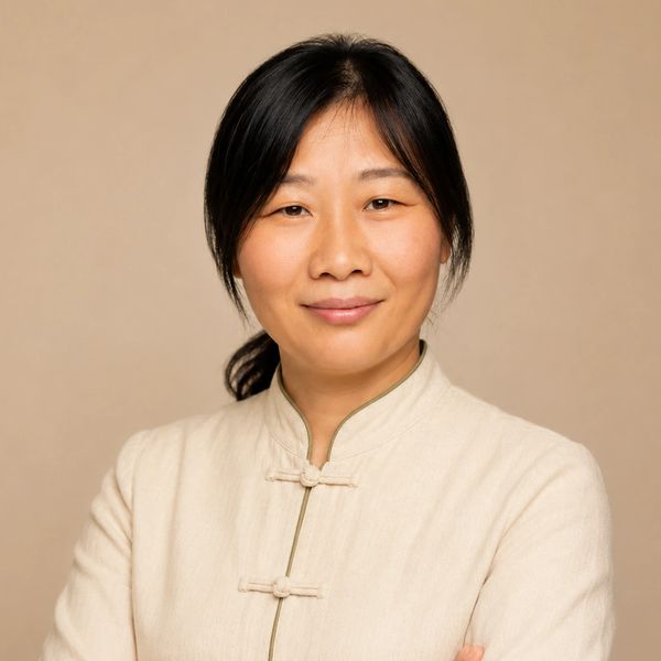 Confident woman in traditional light beige attire.