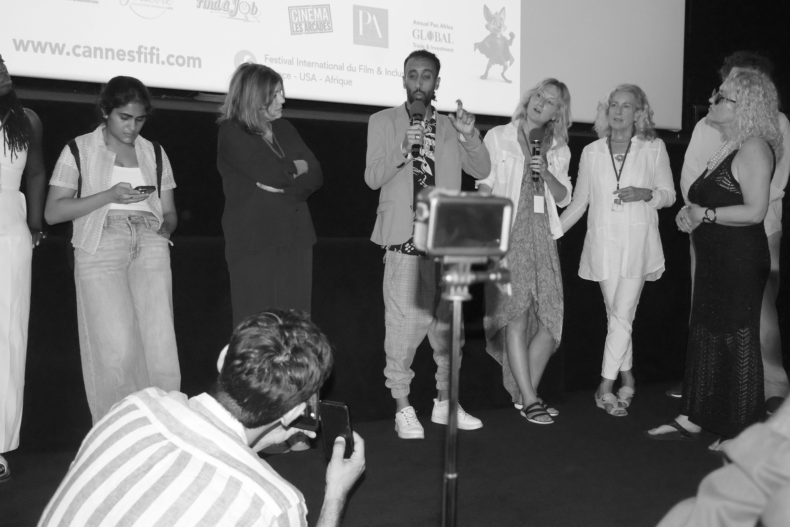 Panel discussion at a film festival with audience recording.