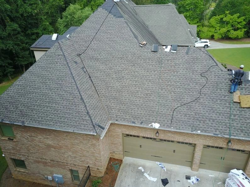 Rooftop under repair with a worker and tools visible.