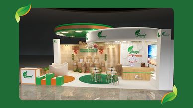 Modern exhibition booth with green and orange branding and seating areas.