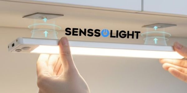 Hands installing a SensoLight under-cabinet LED light with sensor technology.