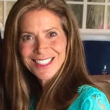 Headshot of a woman with bright smile 