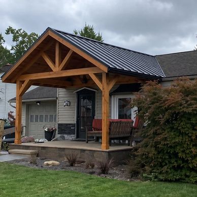 Wooden porch cover with metal roof on a suburban house.