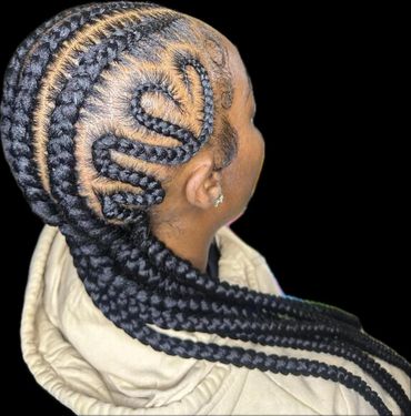 Intricately braided hair with unique swirling patterns and thick cornrows.
