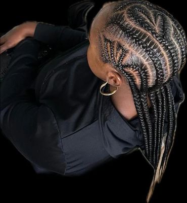 Intricate braided hairstyle with geometric patterns and long braids tied back.