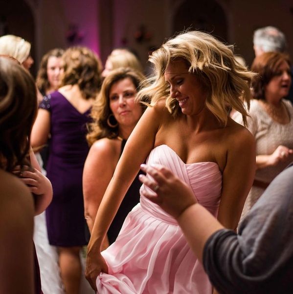 A Woman in pink dress dancing in the party