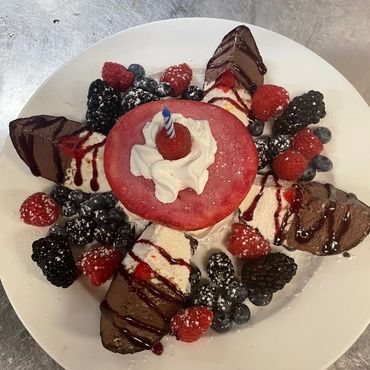 Grilled meat platter served on a rustic wooden table


