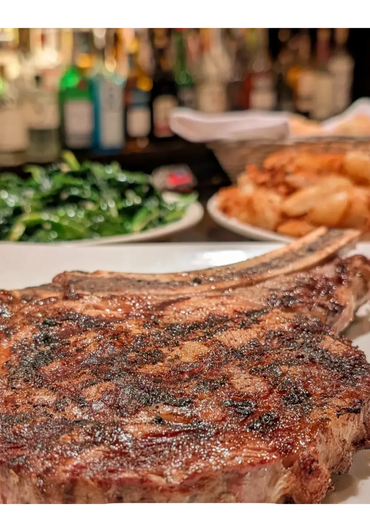 Roasted meat dish with side vegetables on a plate

