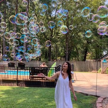 Woman enjoying big soap bubbles
