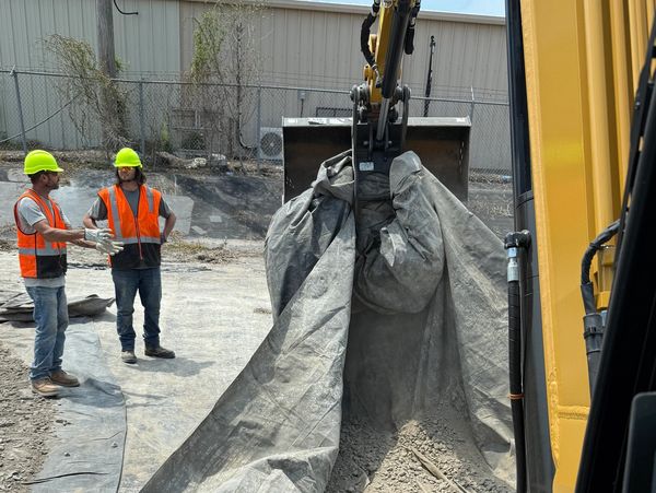 Workers collaborating  to see the job through. 