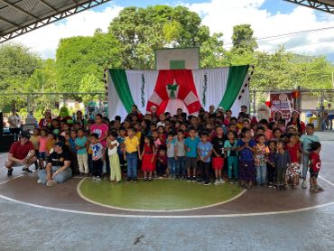 Niños reunidos en un evento bajo un techo.
