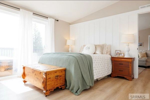 bright master bedroom with board and batten accent wall 