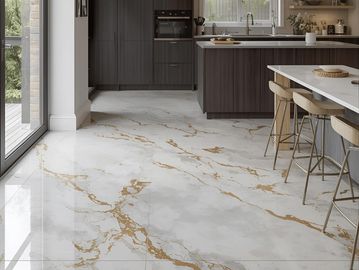 White epoxy floor with gold marble effects in a modern home kitchen, showcasing luxurious flooring.
