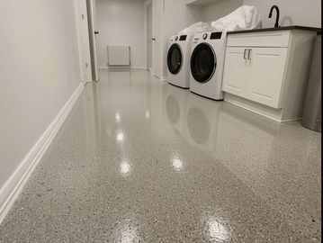 A modern, clean, and durable basement or utility room with a sleek, high-gloss epoxy resin floor.