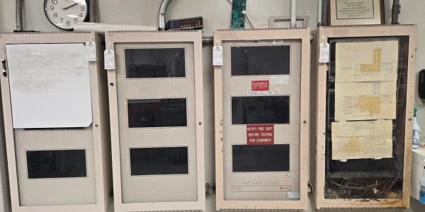 Four beige electrical panels on a wall