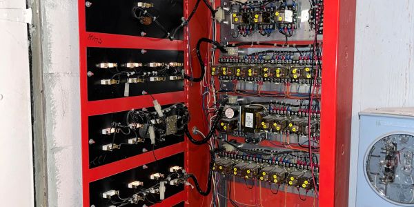 Open electrical control panel with wiring and components.