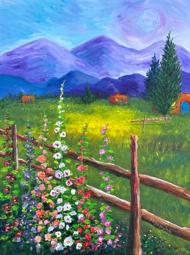 Colorful flowers and a wooden fence with purple mountains in the background.