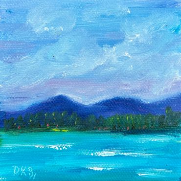 A serene landscape with blue mountains, green trees, and a turquoise lake under a cloudy sky.