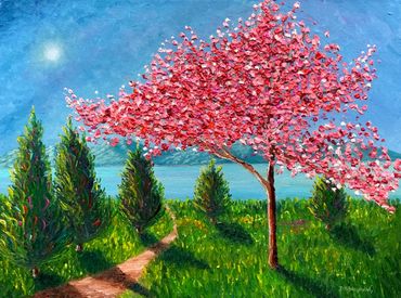 A vibrant pink tree stands by a winding path under a bright blue sky.