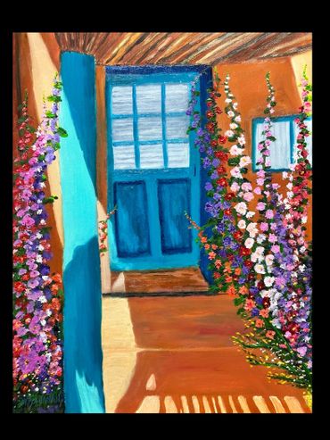 Bright blue door surrounded by colorful blooming flowers in a sunlit porch.