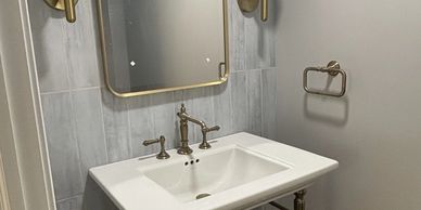 A bathroom with a sink and mirror in it