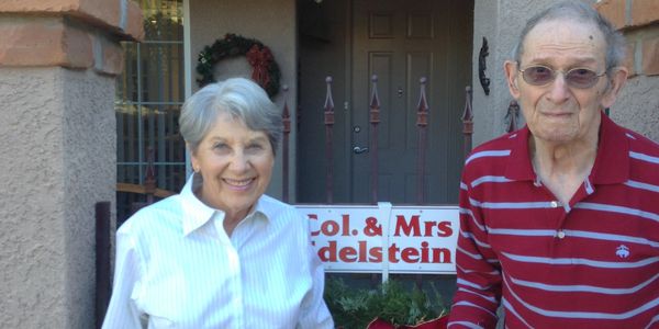Retired couple smiling about the care they receive from At Home Seniors In Tucson, Az. living at The