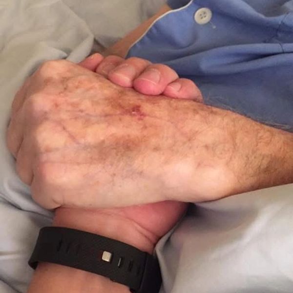 Two clasped hands showing comfort and support.