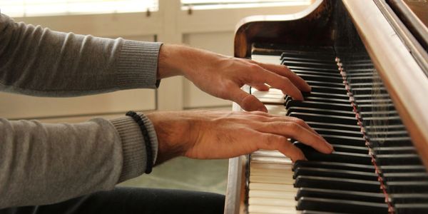 Playing the piano. Holistic Alexander Technique lessons will help you play better.