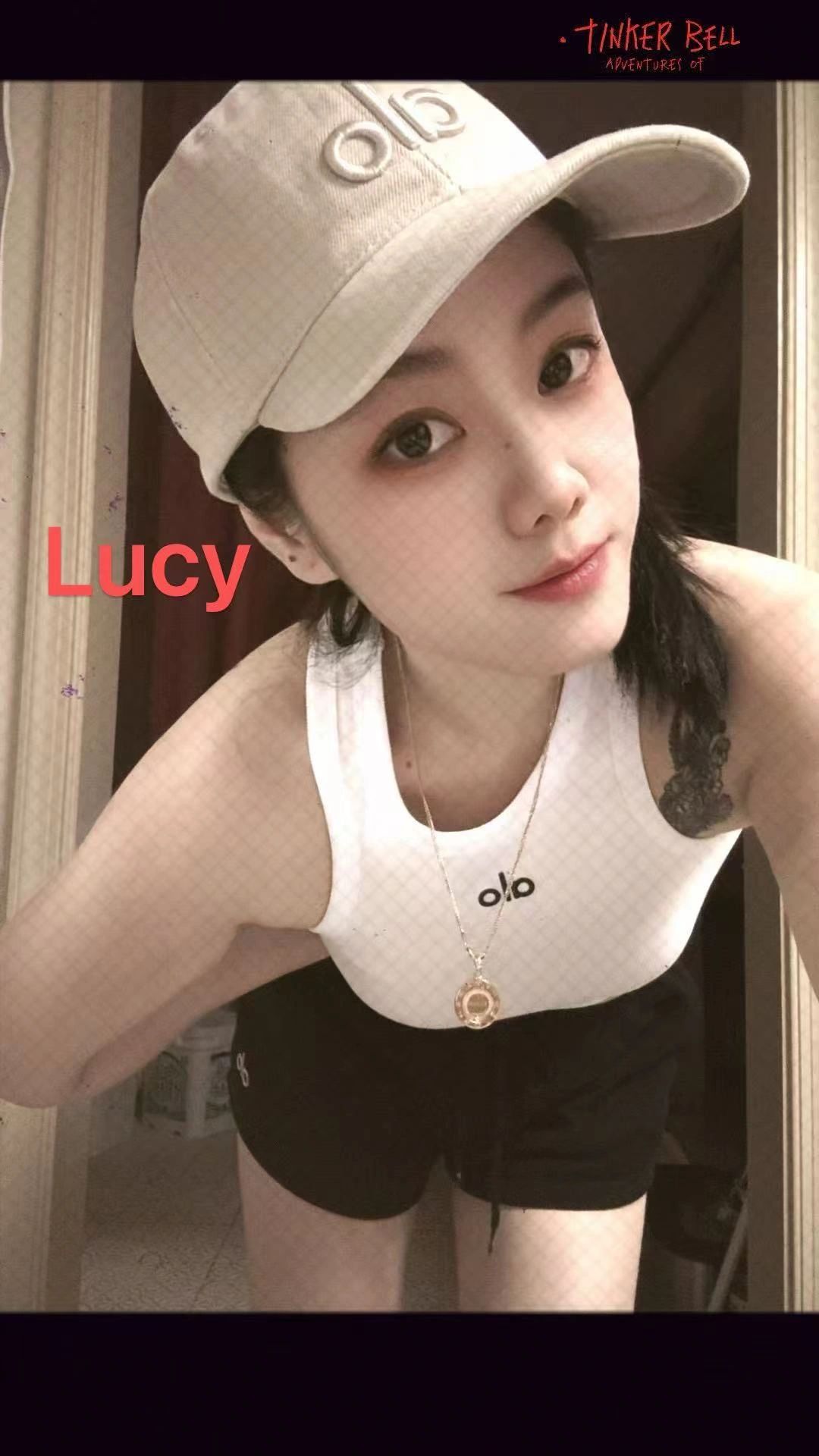 Selfie of a woman named Lucy in sporty attire.